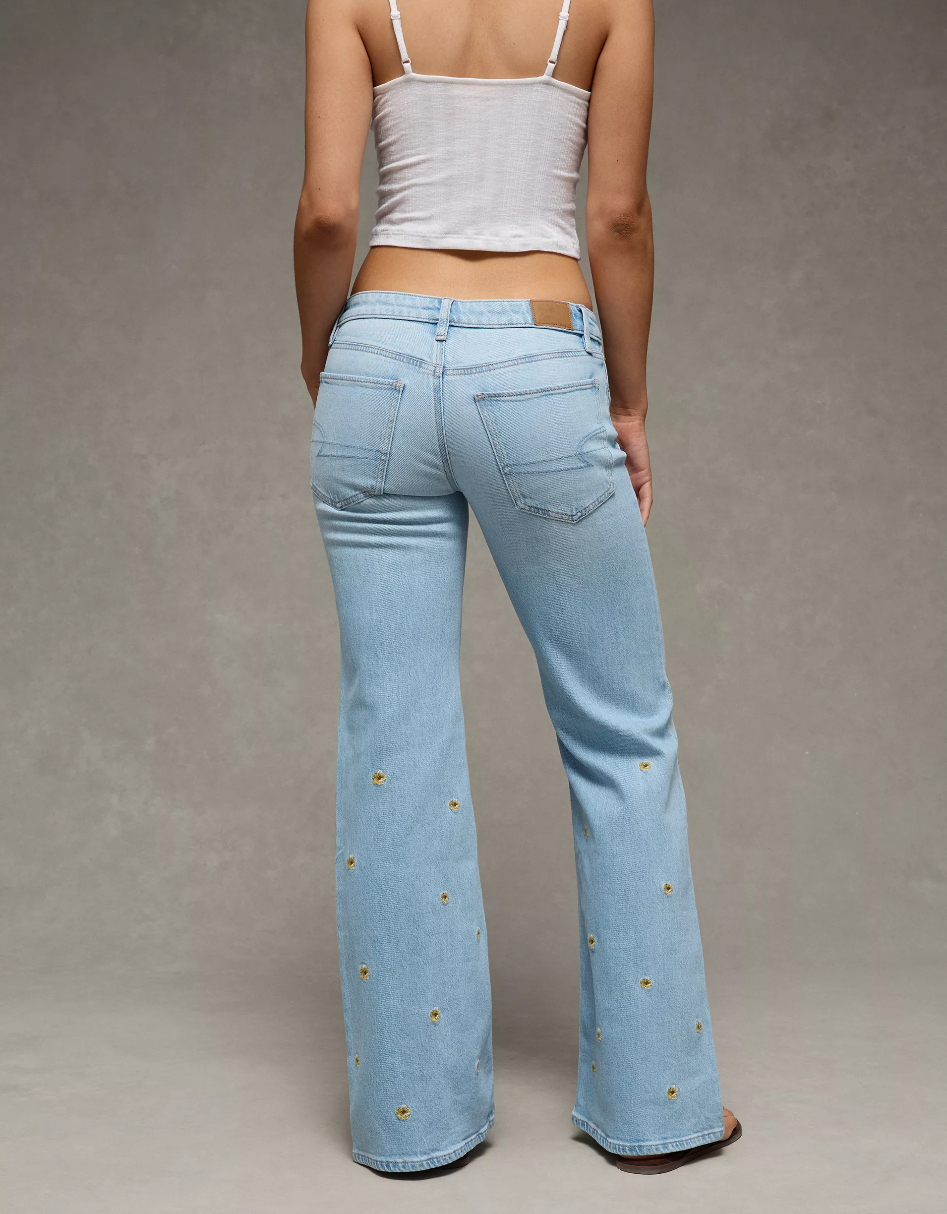 Low-Rise Floral Flare Jean (2) Women's light blue denim flare jean with embroidered floral detail