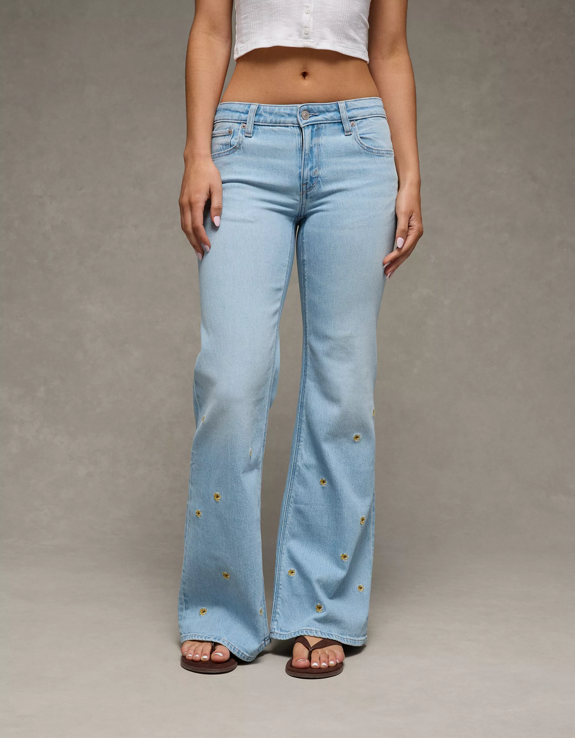 Low-Rise Floral Flare Jean (3) Women's light blue denim flare jean with embroidered floral detail