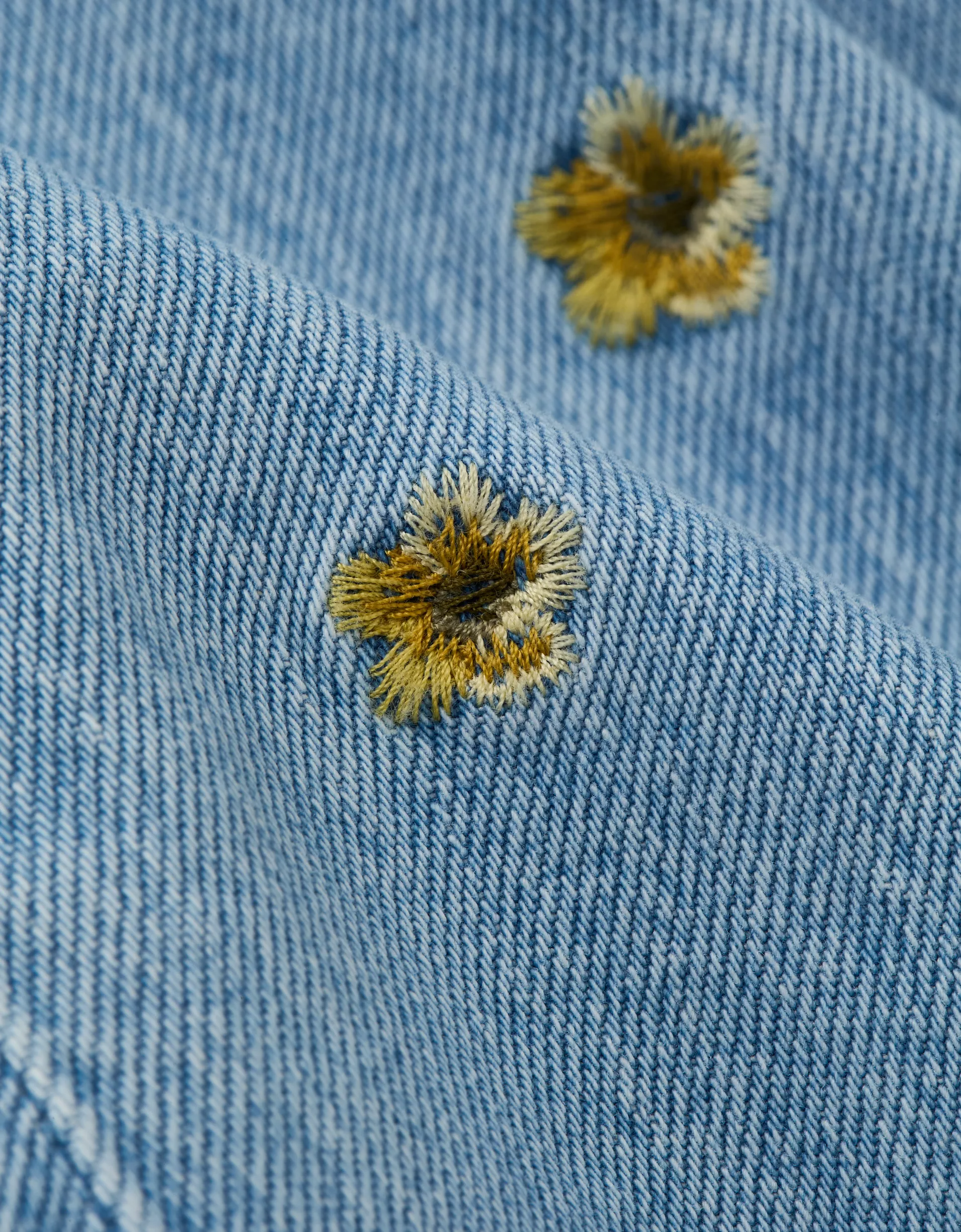 Low-Rise Floral Flare Jean (4) Women's light blue denim flare jean with embroidered floral detail